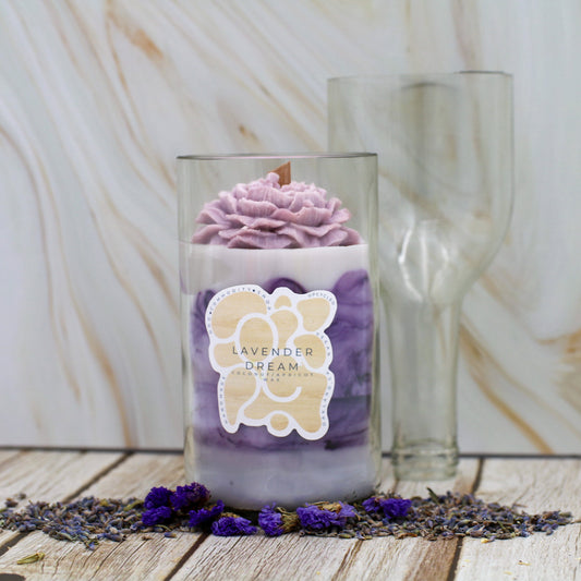 Candle labeled 'Lavender Dream' with lavender flowers on a wooden surface