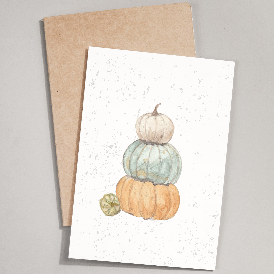 Greeting card with pumpkins design and brown envelope on gray background