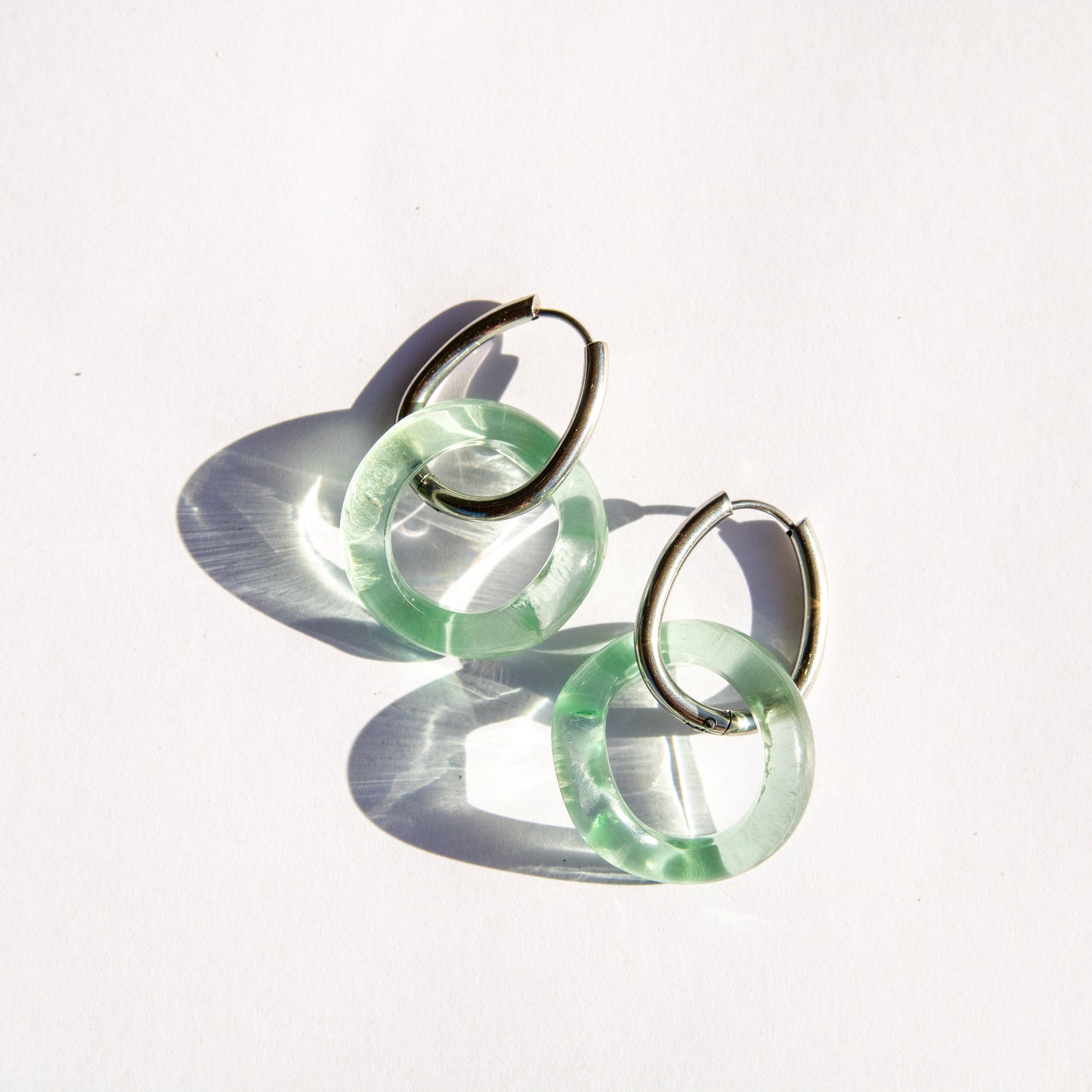 Pair of seafoam hoop earrings on a white background