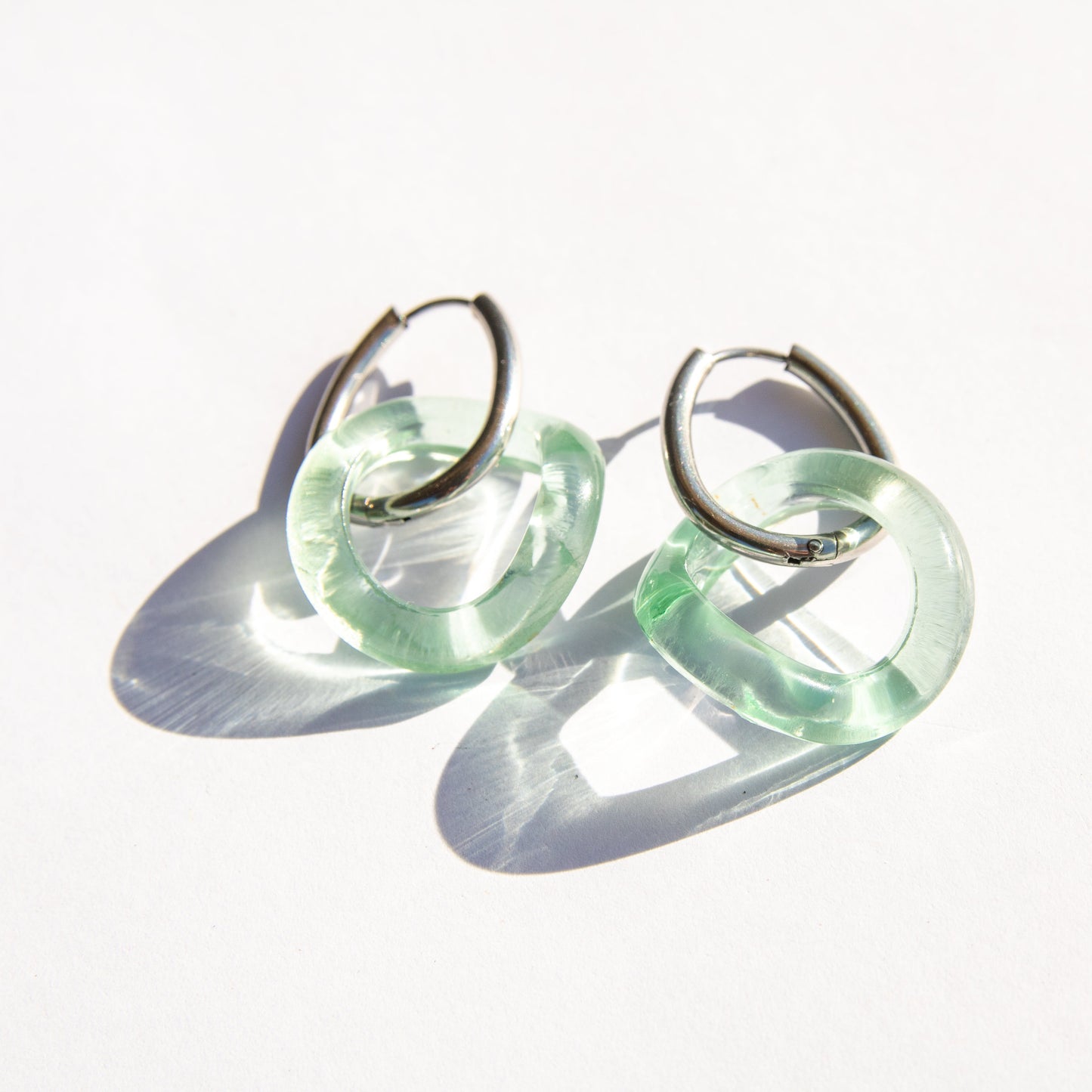 Pair of seafoam hoop earrings on a white background