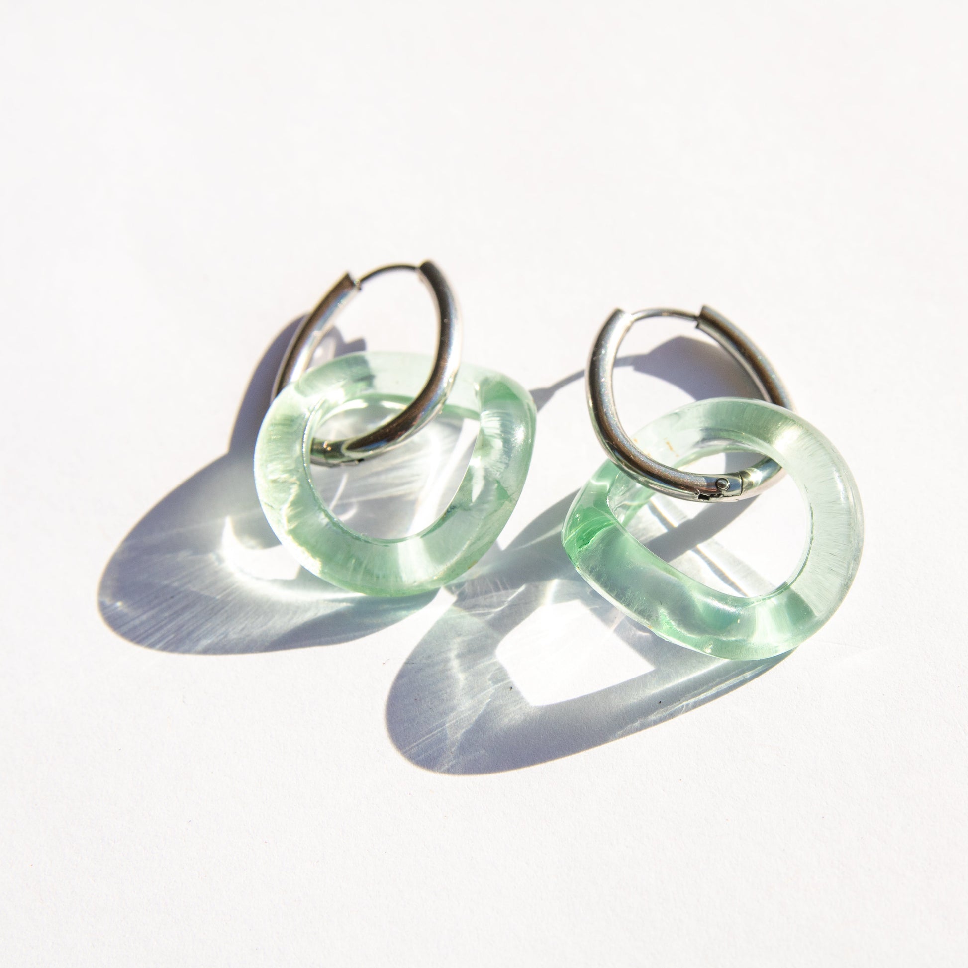Pair of seafoam hoop earrings on a white background
