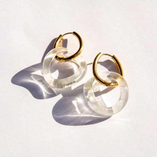 Gold and clear hoop earrings on a white background